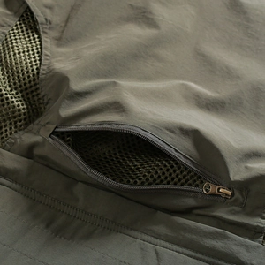 Detail of brass zipper and breathable mesh lining on the utility fishing vest pocket