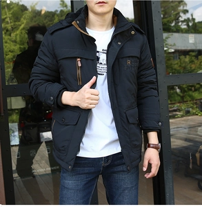 Detail of men's winter parka showing embroidered chest text and tactical front pockets