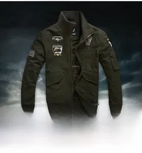 Detail of army green military jacket with tactical embroidery patches and rib cuffs