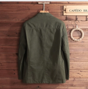 Detail of army green cotton jacket back with vintage stitching and elbow patches