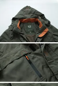 Details einer militärgrünen Outdoorjacke mit orangefarbenem Futter und Brusttasche