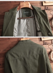 Detail of army green military jacket with striped lining and durable canvas texture