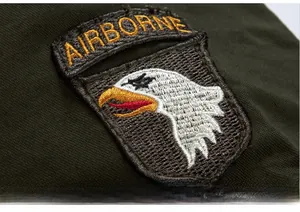 Close-up of military eagle embroidery and Airborne patch on army green bomber jacket
