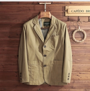 Detail of khaki casual blazer featuring vintage elbow patches and striped interior lining