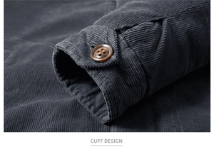Detail view of corduroy jacket cuff featuring ribbed texture and brown resin button