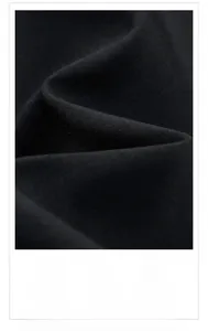 Macro detail of breathable black jacket fabric featuring 3D tailoring and soft texture
