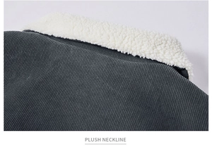 Detail of dark grey corduroy jacket with plush white fleece collar and striped texture