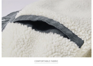 Detailed close-up showing grey corduroy fabric with warm white faux shearling lining texture