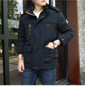 Detailed view of men's black winter parka with fleece lining and rough stock chest embroidery