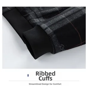 Macro shot of men's jacket showing black and grey plaid fabric with elastic ribbed cuffs