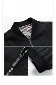 Detail of men's black jacket featuring metal zipper and ribbed cuffs with striped lining