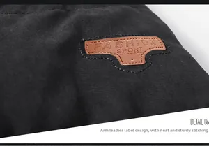 Detail of brown leather patch with Fashion Sport text on black winter coat sleeve