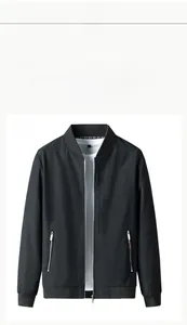 Detail of black bomber jacket with ribbed collar and vertical text embroidery on chest