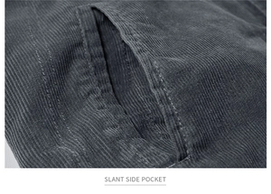 Detail view showing slant side pocket on a dark gray corduroy jacket with fine stitching
