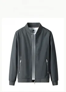 Detail of grey lightweight men's jacket featuring ribbed cuffs and vertical chest print