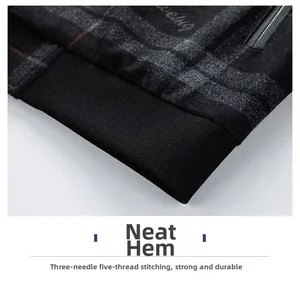 Close-up of snug hem with three-needle five-thread process on men's plaid jacket