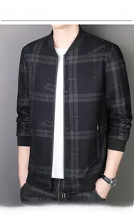 Detail of black bomber jacket featuring classic stand collar and metallic zipper texture