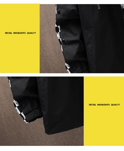 Close-up of black streetwear jacket featuring checkerboard patterns and metal snap buttons
