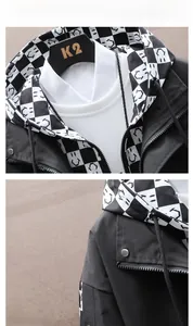 Detail of black hooded jacket featuring checkered inner lining and stylish collar zipper