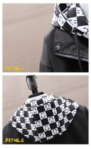 Detail of hood with black and white checkerboard print and smiley face pattern