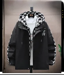 Detail of hooded jacket featuring checkerboard panels, drawstring, and bear badge