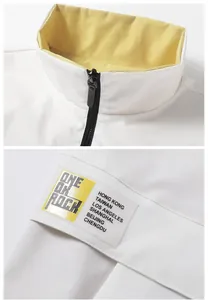 Detail of white stand collar vest with yellow lining and One Ok Rock printed graphics