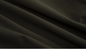 Detailed macro view of olive green twill cotton fabric texture for men's casual jacket