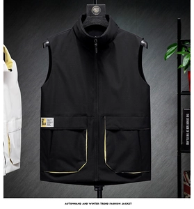 Detail of black stand collar vest showing large pockets and yellow contrast lining