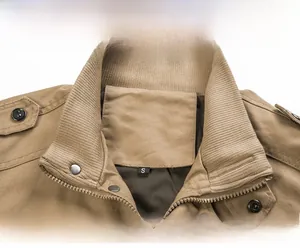Close-up of khaki cotton workwear jacket collar with ribbed knit and metal zipper