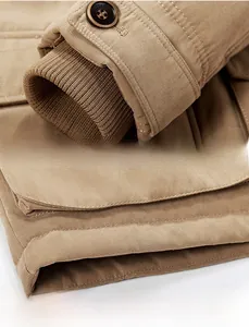 Detailed view of khaki jacket ribbed cuffs with classic buttons and stitched hemline
