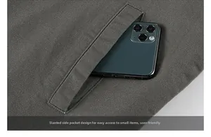 Close-up of a men's outdoor jacket diagonal pocket showing storage for a mobile phone