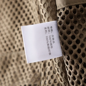 Detail of tactical vest showing breathable mesh lining and fabric care label