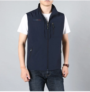 Detail view of navy blue outdoor vest with stand collar and functional zip pockets
