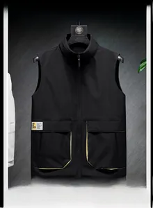 Detail of black vest with large utility pockets and vibrant yellow contrast piping
