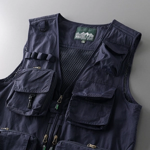 Detail showing the inner mesh lining, size label, and multi-pocket design of the tactical vest