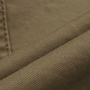 Macro shot of khaki cotton twill fabric texture and fine stitching on men's casual blazer