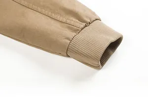Detail of khaki cotton jacket sleeve with elastic ribbed cuff and high quality twill texture