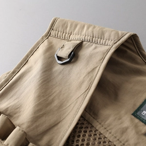 Detail of tactical vest shoulder with matte black D-ring and breathable mesh lining