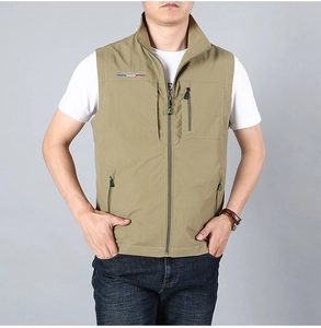 Detail of professional outdoor embroidery and zipper pockets on khaki fishing vest