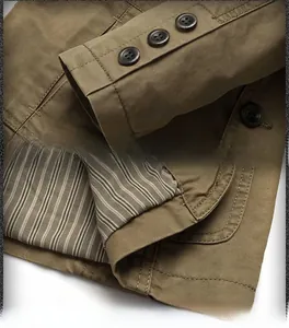 Detail of khaki cotton jacket showing triple-button cuffs and striped lining texture