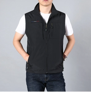 Detail of black quick-dry outdoor vest featuring zippered pocket and striped embroidery