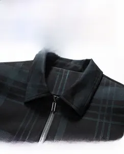 Detail of classic polo collar and metal zipper on green plaid jacket for men