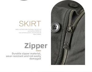 Detailed close-up of heavy-duty metal zipper and resin button on a green utility skirt