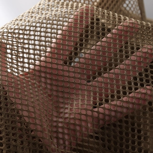 Detail shot of brown breathable mesh fabric on a tactical vest with hollow grid structure