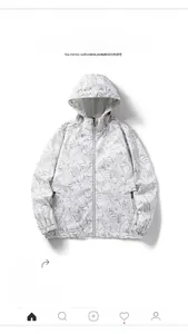 Detail of white windbreaker with tropical leaf print and adjustable drawstring hood