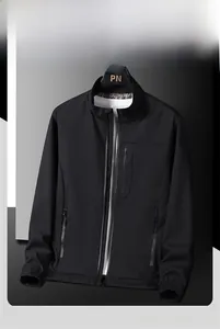 Close-up of black casual jacket with stand collar and functional zipper pockets details