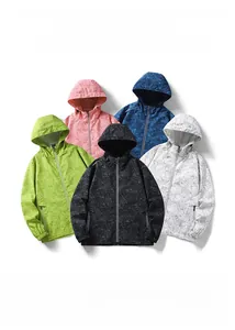 Flat lay of multiple windbreaker jackets in tropical leaf prints and various colors