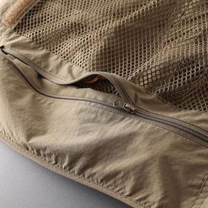 Close-up of khaki tactical vest featuring durable nylon fabric and breathable mesh details