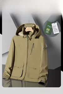 Close-up of khaki hooded workwear jacket featuring chest embroidery and arm badge details
