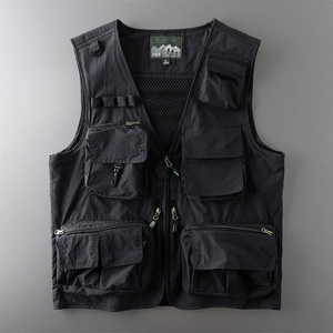 Detail of multi-pocket black tactical vest showing mesh lining and durable metal zippers